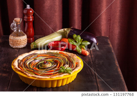 Process of cooking vegetable spiral tart with zucchini, eggplant, carrots, bell pepper, basil in silicone baking dish Process of cooking vegetable spiral tart with zucchini, eggplant, carrots, bell pepper, basil in silicone baking dish 131197768