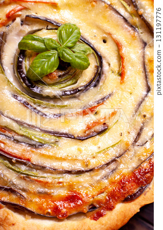 Background of Vegetable Spiral tart with zucchini, eggplant, carrot with a sprig of basil, close up macro shoot 131197776
