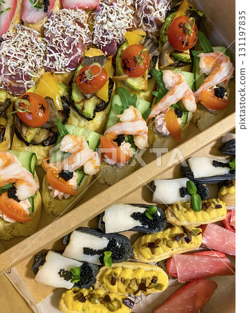 Box with small sandwiches with cold cuts, grilled vegetables, cheese and seafood. Charcuterie boards to order Box with small sandwiches with cold cuts, grilled vegetables, cheese and seafood. Charcuterie boards to order 131197835
