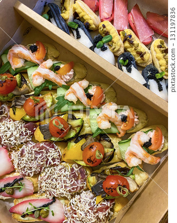 Box with small sandwiches with cold cuts, grilled vegetables, cheese and seafood. Charcuterie boards to order Box with small sandwiches with cold cuts, grilled vegetables, cheese and seafood. Charcuterie boards to order 131197836