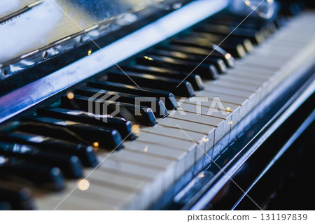 The keys of an old vintage piano in the background light with highlights. The keys of an old vintage piano in the background light with highlights. 131197839