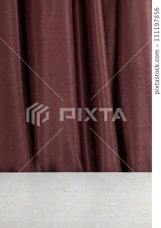 Brown textured fabric drapes elegantly over a smooth countertop with subtle lighting effects in a modern setting Brown textured fabric drapes elegantly over a smooth countertop with subtle lighting effects in a modern setting 131197856