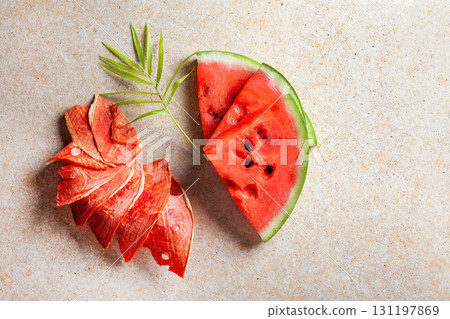 Winter supplies: slices of dried watermelon with fresh pieces on light background Winter supplies: slices of dried watermelon with fresh pieces on light background 131197869