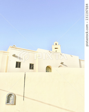 Stunning djerba mosque featuring unique architecture against the clear blue sky 131197884