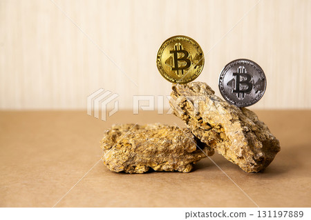 Gold and silver Bitcoin Coins balances on natural stones on light background. Blockchain cryptocurrency, store of value 131197889
