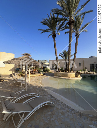 Experience relaxation at a beautiful Airbnb pool in Djerba, Tunisia surrounded by palm trees and 131197912