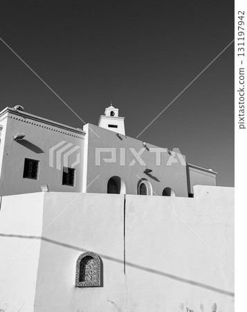 Stunning djerba mosque featuring unique architecture against the clear blue sky Stunning djerba mosque featuring unique architecture against the clear blue sky 131197942
