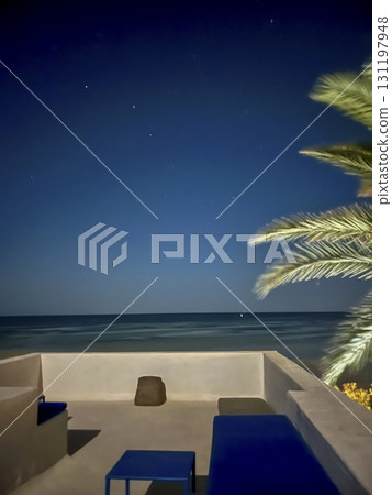 Starry night view from a white house roof in Djerba, Tunisia showcasing a peaceful atmosphere and Starry night view from a white house roof in Djerba, Tunisia showcasing a peaceful atmosphere and 131197948