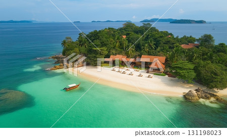Tropical island beach view with a house and traditional wooden boat near 131198023