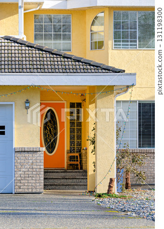 Orange door of residential house main entrance on bright sunny day 131198300