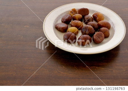 Peeled sweet chestnuts on the table background Peeled sweet chestnuts on the table background 131198763