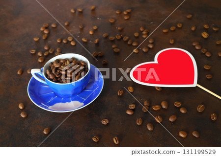 coffee beans stripes isolated in dark background. Frame with coffee beans and blue coffee cup. 131199529