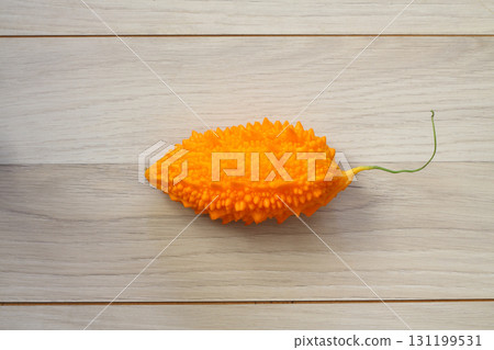 Momordica charantia isolated on a wooden background. Ripe whole fruits of Momordica charantia 131199531