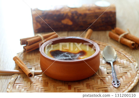 Baked rice pudding turkish dessert sutlac in earthenware casserole with cinnamon sticks Baked rice pudding turkish dessert sutlac in earthenware casserole with cinnamon sticks 131200110