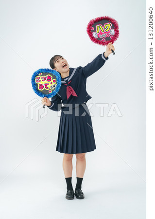 Full-body photo of a female student wearing a sailor uniform holding a fan 131200640