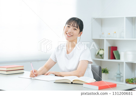 Teenage woman studying in a room Teenage woman studying in a room 131200681