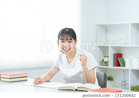 Teenage woman studying in a room 131200682