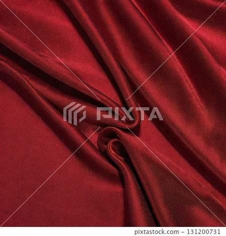 Soft burgundy satin lies elegantly folded, its rich texture catching the subtle light. Each curve and crease tells a story of sophistication, inviting touch and exploration Generative AI 131200731