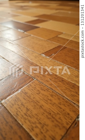 Light streams across a beautifully patterned wooden floor, illuminating the rich textures and natural grains. This cozy setting exudes warmth and tranquility, inviting relaxation Generative AI 131201341