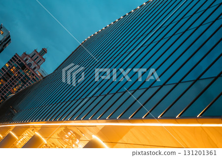 illuminated glass facade of modern skyscraper at night, sleek reflective design of contemporary high-rise building glowing illuminated glass facade of modern skyscraper at night, sleek reflective design of contemporary high-rise building glowing 131201361