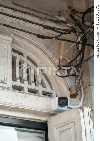 surveillance camera with chaotic wires in typical Asian street, cluttered cables on wall surveillance camera with chaotic wires in typical Asian street, cluttered cables on wall 131201375