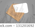 Natural lighting casts shadows from the field grass on an envelope with a sheet of white paper lying on a gray background. Mockup 131201692