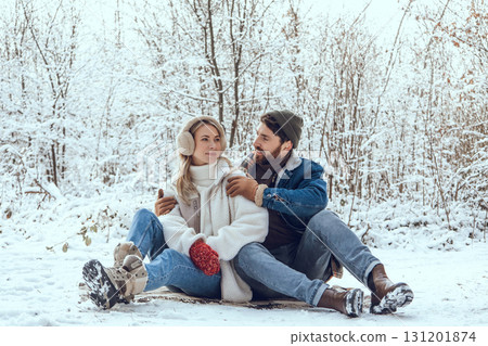 Happy young couple in the winter forest feeling excited and enjoyed 131201874