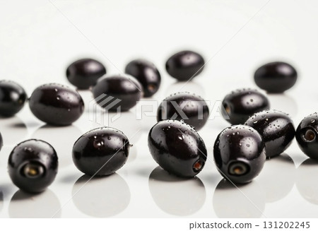 Clusters of fresh black olives glisten with droplets of water, their deep hue contrasting beautifully against a pristine white surface, evoking freshness and culinary delight Generative AI 131202245