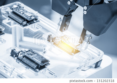 Close up scene the micro circuit board assembly process by robotic arm in the light blue scene. Close up scene the micro circuit board assembly process by robotic arm in the light blue scene. 131202318