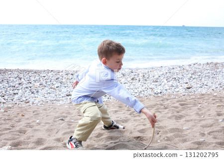 little cute boy playing on beach, lifestyle people concept 131202795