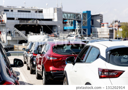 Terminal for passenger ferry transport in the city. Line of cars waiting to board the ferry. 131202914
