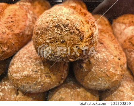 Freshly baked artisan bread loaves in a warm bakery setting during morning hours Freshly baked artisan bread loaves in a warm bakery setting during morning hours 131203239