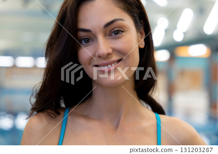 Waist up of a beautiful smiling woman at the pool 131203287