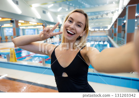 Cute smiling blonde young woman making selfie at the pool Cute smiling blonde young woman making selfie at the pool 131203342