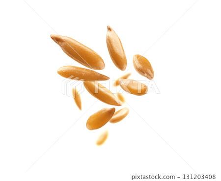 Flax seeds are levitated on a white background Flax seeds are levitated on a white background 131203408