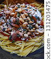 Spaghetti with Greek yogurt, tomato sauce, nuts and seeds. Spaghetti pasta with Greek yogurt and tomato sauce, topped with peanuts, almonds, pumpkin and sunflower seeds. Creative vegetarian meal, clos 131203475