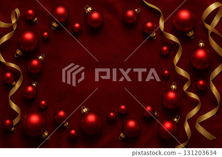 Red background with golden baubles and holiday ornaments creating festive decorative frame. 131203634