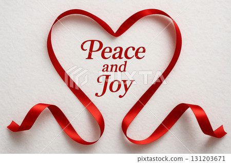 Peace And Joy text with red ribbon shaped as heart on white background. 131203671