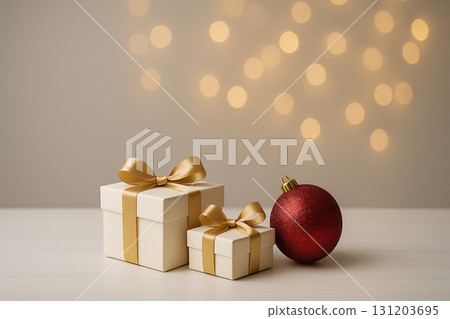 Red bauble with golden gifts on soft glowing festive background. Red bauble with golden gifts on soft glowing festive background. 131203695
