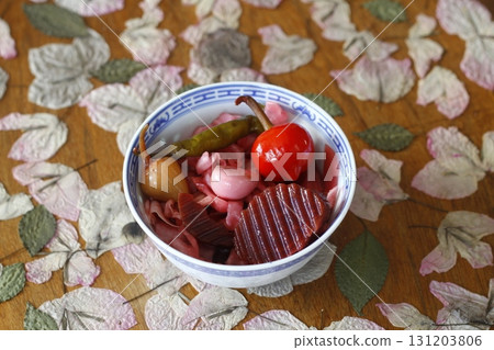 Red pickled cabbage in white bowl on wooden background Red pickled cabbage in white bowl on wooden background 131203806