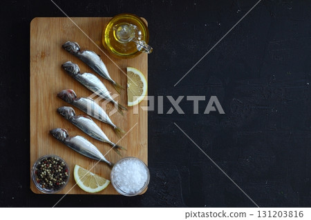 Fresh fish horse mackerel on a dark background Fresh fish horse mackerel on a dark background 131203816