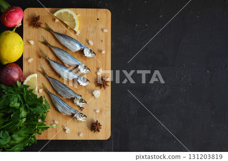 Fresh fish horse mackerel on a dark background Fresh fish horse mackerel on a dark background 131203819