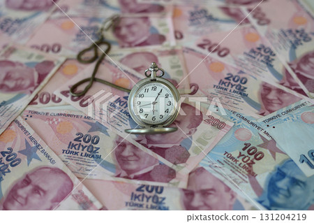 Turkish lira and old clock. Selective Focus. Turkish lira and old clock. Selective Focus. 131204219