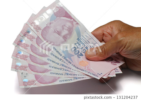 Senior man wrinkled hands holding Turkish Lira banknotes on white background. 131204237