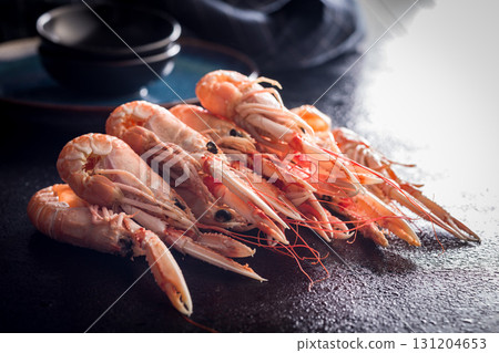 Scampi langoustine on black table. Scampi langoustine on black table. 131204653