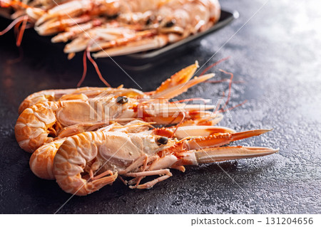Scampi langoustine on black table. 131204656