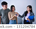 A consultant discussing product benefits with a couple in an office setting. 131204784