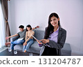 Professional woman facilitating a discussion between an estranged couple in a modern room. 131204787