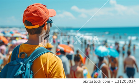 A young man enjoys a vibrant beach scene, surrounded by colorful umbrellas and lively crowds under a sunny sky. 131206034