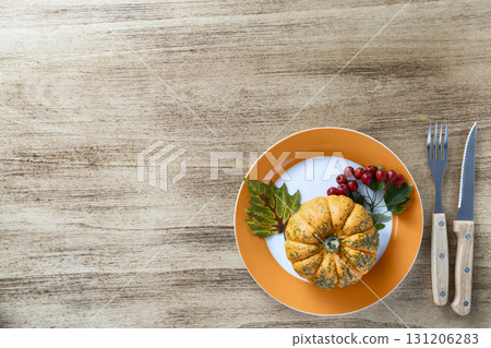 Thanksgiving concept with pumpkin and viburnum branch 131206283